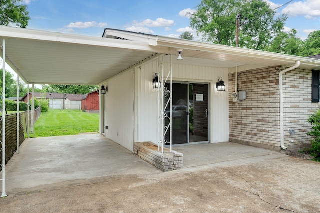 exterior space with a yard, brick siding, fence, and a patio area