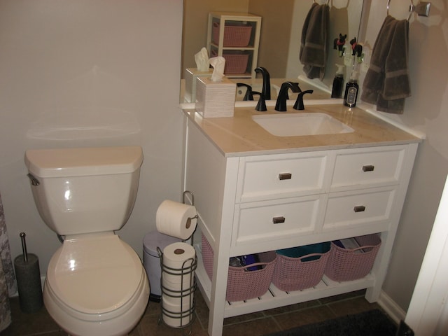 bathroom featuring vanity, tile patterned floors, and toilet