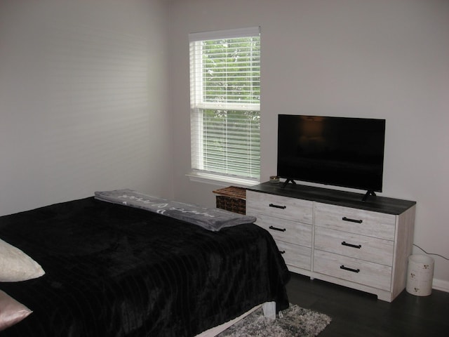 bedroom with dark wood-style floors
