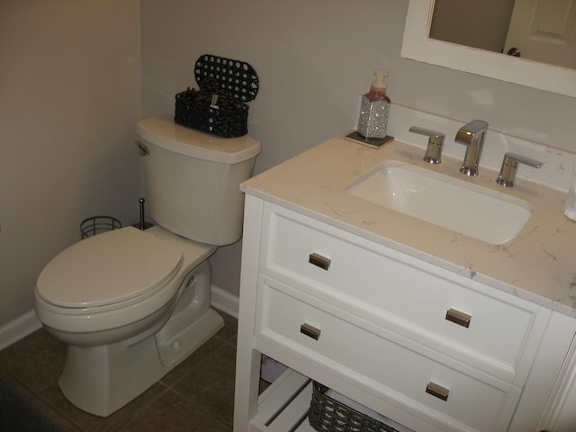 bathroom featuring toilet, tile patterned flooring, and vanity