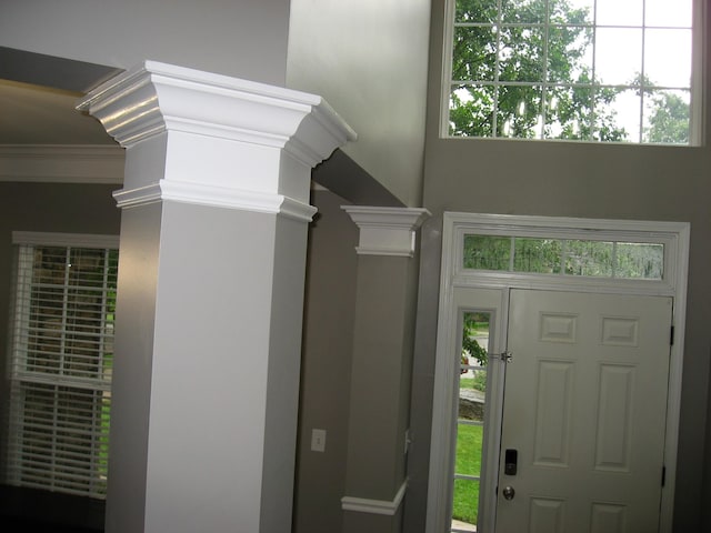 entrance foyer with ornamental molding and ornate columns