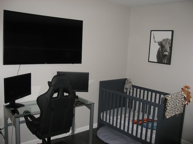bedroom featuring baseboards and wood finished floors