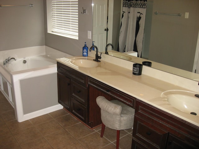 bathroom with a sink, a garden tub, and double vanity