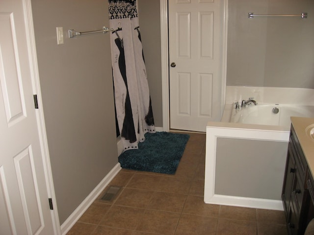 full bathroom featuring a bath, visible vents, tile patterned floors, baseboards, and vanity