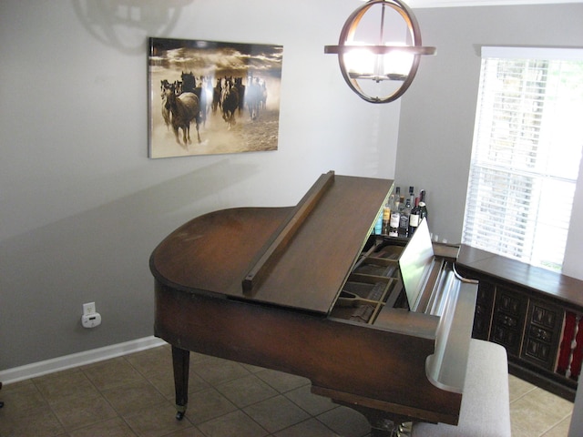 dining space featuring a dry bar, tile patterned flooring, and baseboards