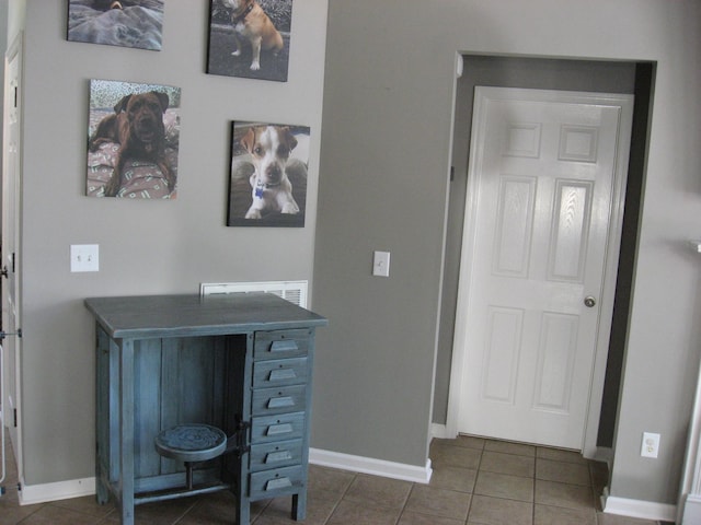 interior space with tile patterned flooring and baseboards