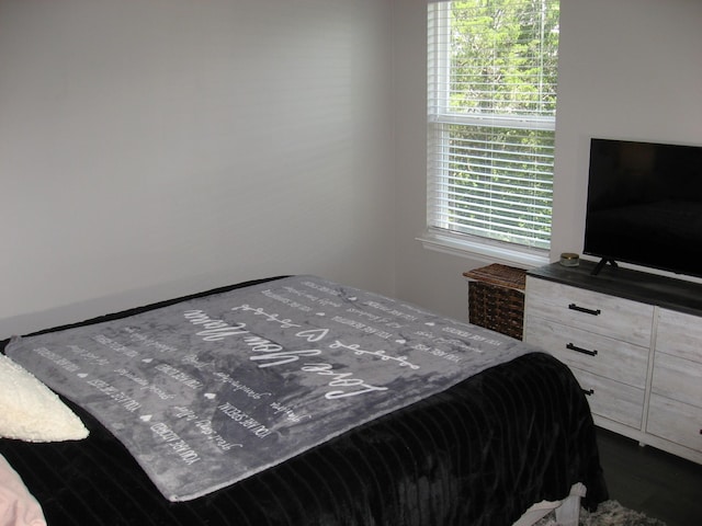 bedroom with dark wood-type flooring
