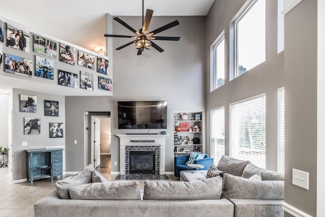 1505 Sylvan Park Ct, Mount Juliet, TN 37122 - living area with a high ceiling, a ceiling fan, a tiled fireplace, baseboards, and tile patterned floors