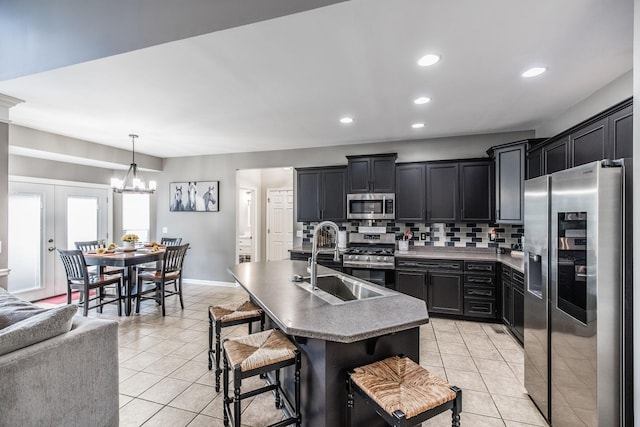 1505 Sylvan Park Ct, Mount Juliet, TN 37122 - kitchen featuring appliances with stainless steel finishes, light tile patterned flooring, decorative backsplash, dark cabinets, and recessed lighting