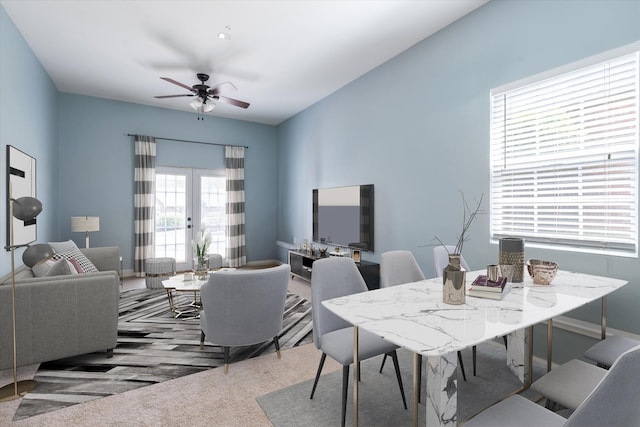 carpeted dining area featuring a ceiling fan and french doors