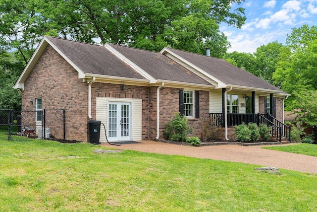 single story home with covered porch, french doors, roof with shingles, brick siding, and a front lawn