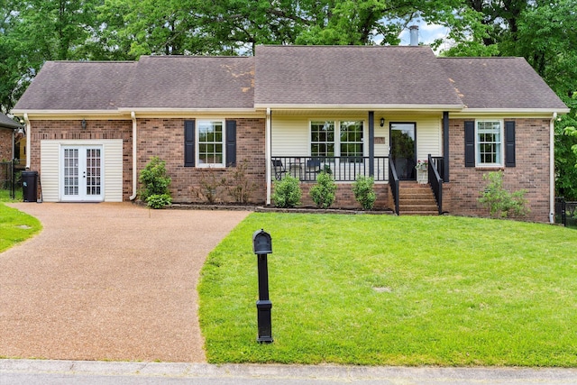 single story home featuring french doors, a porch, a front lawn, and brick siding