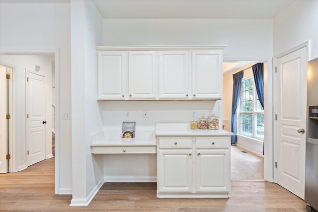 1069 Fitzpatrick Rd, Nashville, TN 37214 - kitchen with light wood-style flooring, baseboards, and white cabinets