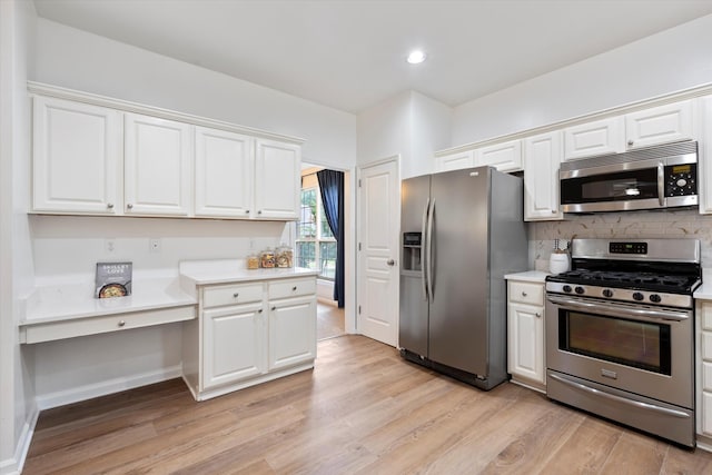 1069 Fitzpatrick Rd, Nashville, TN 37214 - kitchen featuring appliances with stainless steel finishes, light countertops, light wood-type flooring, white cabinets, and recessed lighting