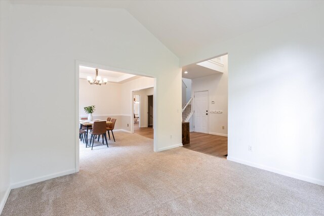 1069 Fitzpatrick Rd, Nashville, TN 37214 - unfurnished room featuring carpet, stairway, a chandelier, baseboards, and high vaulted ceiling