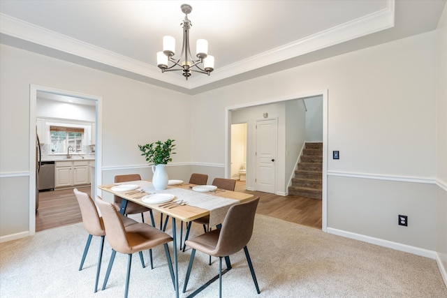 1069 Fitzpatrick Rd, Nashville, TN 37214 - dining space with a chandelier, stairway, ornamental molding, a tray ceiling, and light carpet