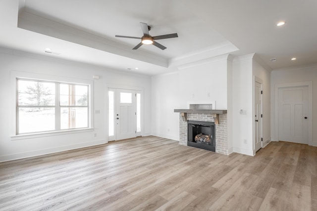 492 Willow Grove Ct Unit 60, Ringgold, GA 30736 - unfurnished living room featuring a ceiling fan, crown molding, a brick fireplace, a raised ceiling, and light wood finished floors