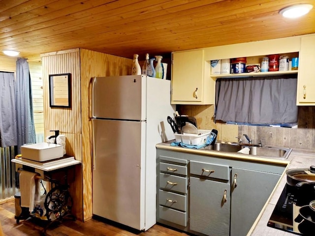 4179 Beaver Bend Dr, Nunnelly, TN 37137 - kitchen with freestanding refrigerator, wood walls, wood finished floors, wood ceiling, and a sink