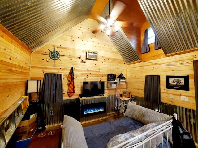 4179 Beaver Bend Dr, Nunnelly, TN 37137 - living room with wooden walls, ceiling fan, vaulted ceiling, and a glass covered fireplace