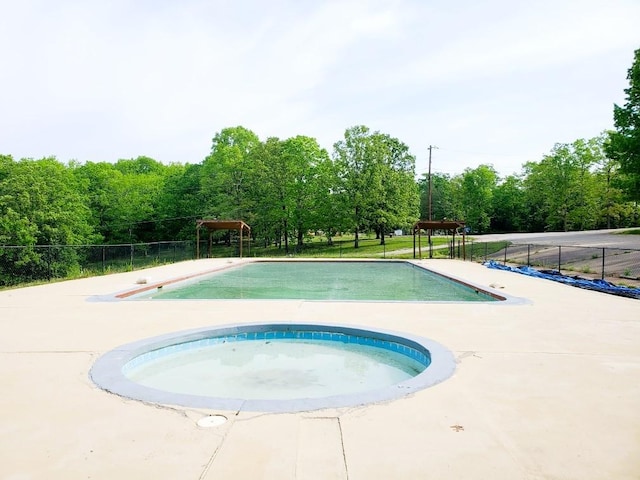 4179 Beaver Bend Dr, Nunnelly, TN 37137 - view of swimming pool with fence, a fenced in pool, and an in ground hot tub