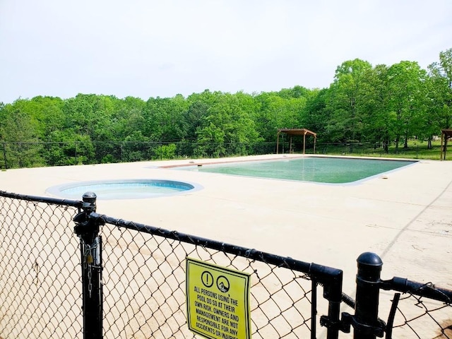 4179 Beaver Bend Dr, Nunnelly, TN 37137 - view of swimming pool featuring fence, a fenced in pool, and a wooded view