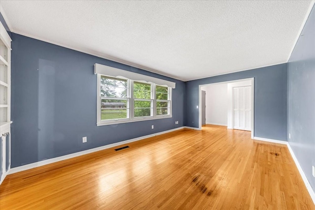 419 Westwood Dr, Tullahoma, TN 37388 - spare room featuring a textured ceiling, wood finished floors, and baseboards