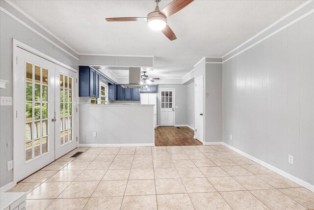 419 Westwood Dr, Tullahoma, TN 37388 - unfurnished living room with a ceiling fan, french doors, ornamental molding, light tile patterned flooring, and baseboards