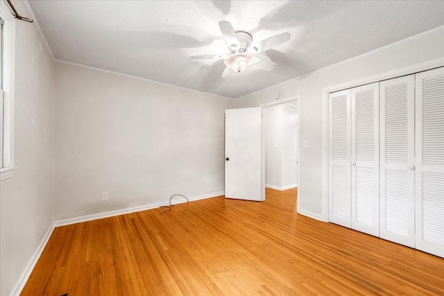 419 Westwood Dr, Tullahoma, TN 37388 - unfurnished bedroom with light wood-style flooring, baseboards, a closet, a textured ceiling, and ceiling fan
