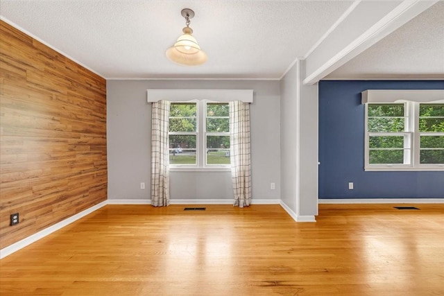 419 Westwood Dr, Tullahoma, TN 37388 - spare room featuring wood walls, crown molding, light wood-style floors, a textured ceiling, and baseboards