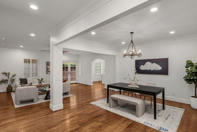 dining area with arched walkways, baseboards, and recessed lighting