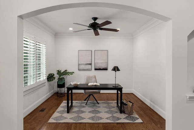 office with dark wood-style flooring, ceiling fan, arched walkways, baseboards, and ornamental molding