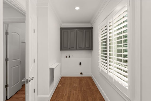 clothes washing area featuring cabinet space, electric dryer hookup, dark wood finished floors, and washer hookup