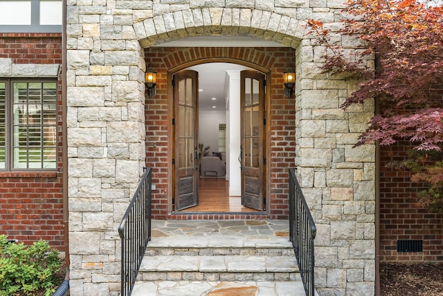 entrance to property with brick siding and stone siding