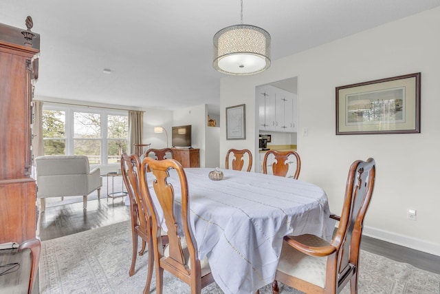 dining room featuring baseboards and wood finished floors