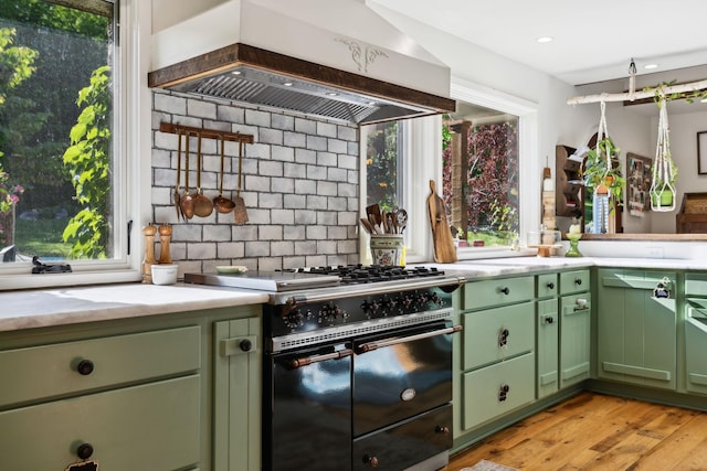 503 Brick Church Pike, Goodlettsville, TN 37072 - kitchen with green cabinetry, double oven range, a wealth of natural light, light countertops, and custom exhaust hood