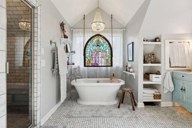 503 Brick Church Pike, Goodlettsville, TN 37072 - full bathroom with lofted ceiling, baseboards, an inviting chandelier, vanity, and a freestanding bath