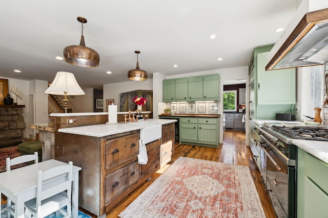 503 Brick Church Pike, Goodlettsville, TN 37072 - kitchen with hardwood / wood-style floors, wall chimney exhaust hood, stainless steel stove, green cabinets, and a kitchen island