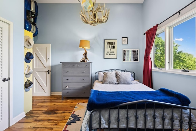 503 Brick Church Pike, Goodlettsville, TN 37072 - bedroom with baseboards, an inviting chandelier, and wood finished floors