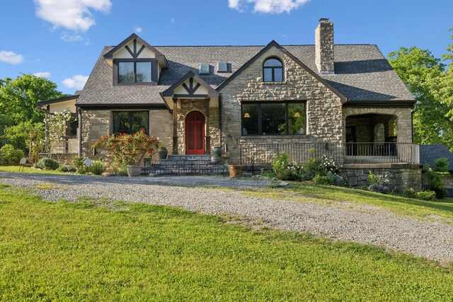 503 Brick Church Pike, Goodlettsville, TN 37072 - tudor-style house featuring a shingled roof, a front lawn, a chimney, and stone siding