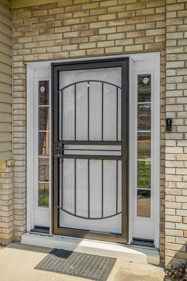 property entrance with brick siding