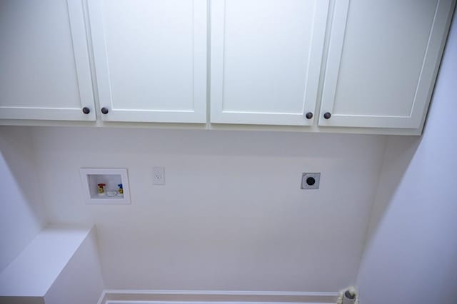 clothes washing area with hookup for an electric dryer, cabinet space, and washer hookup