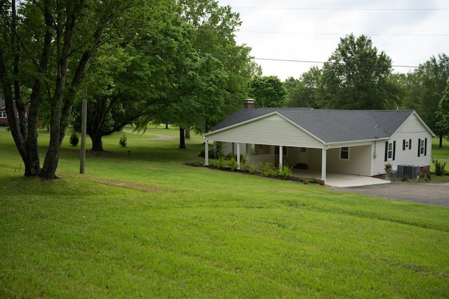 surrounding community with a yard, aphalt driveway, and a carport