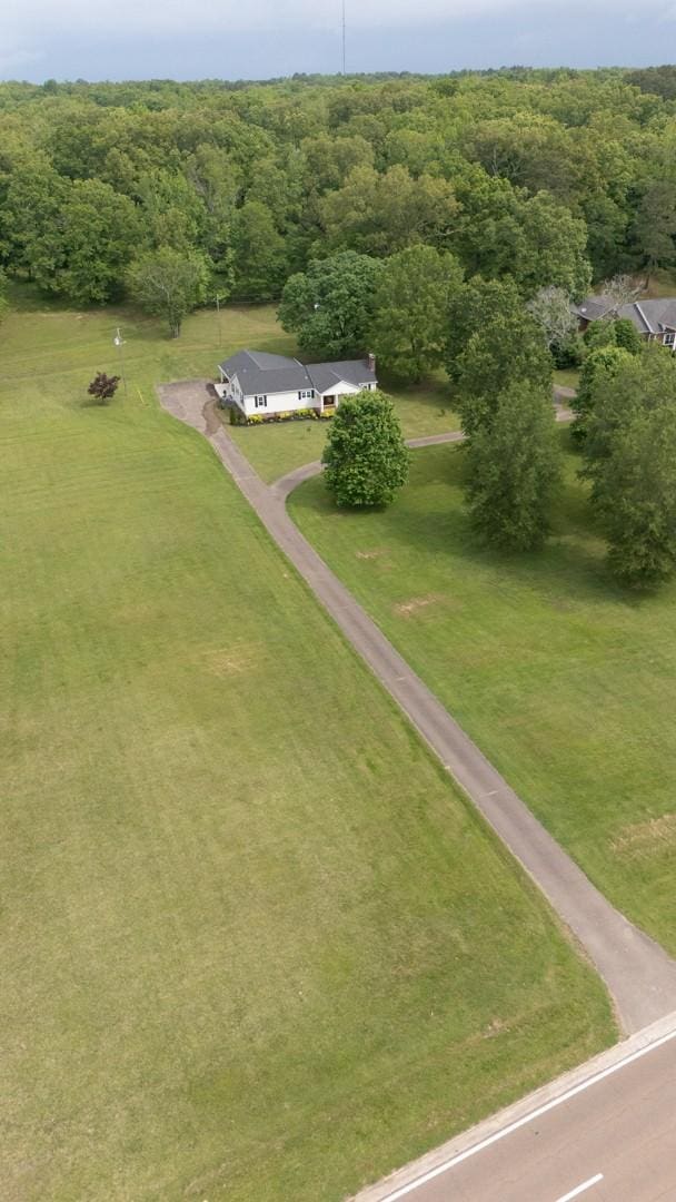 birds eye view of property with a view of trees