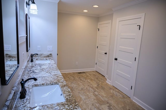 full bathroom featuring ornamental molding, recessed lighting, a sink, and double vanity
