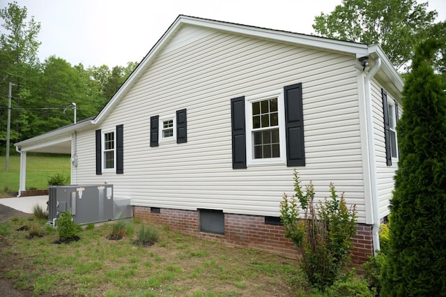view of property exterior featuring a carport and crawl space