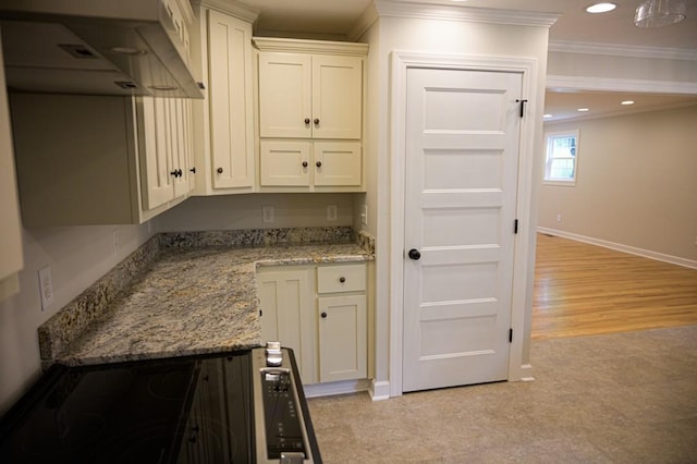 kitchen with white cabinets, crown molding, baseboards, light stone counters, and recessed lighting