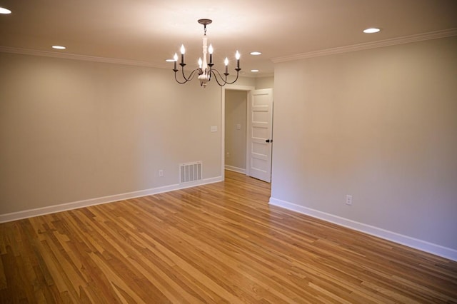 empty room with crown molding, visible vents, light wood-style floors, a chandelier, and recessed lighting