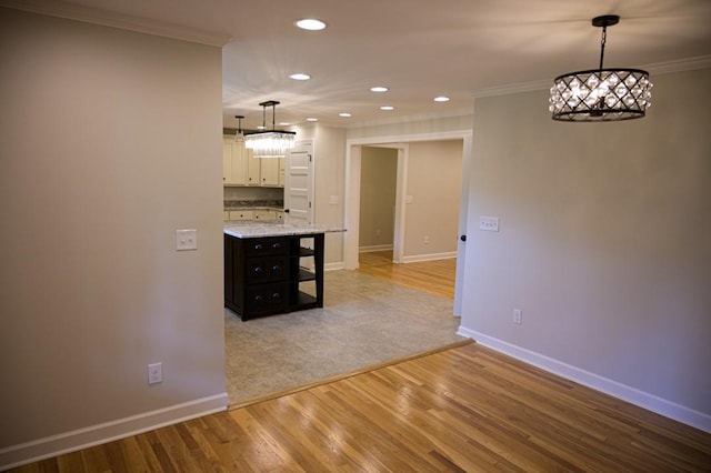 interior space featuring recessed lighting, baseboards, a chandelier, crown molding, and light wood-type flooring