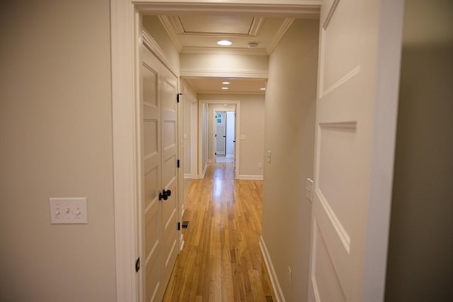 corridor featuring light wood-type flooring, baseboards, ornamental molding, and recessed lighting