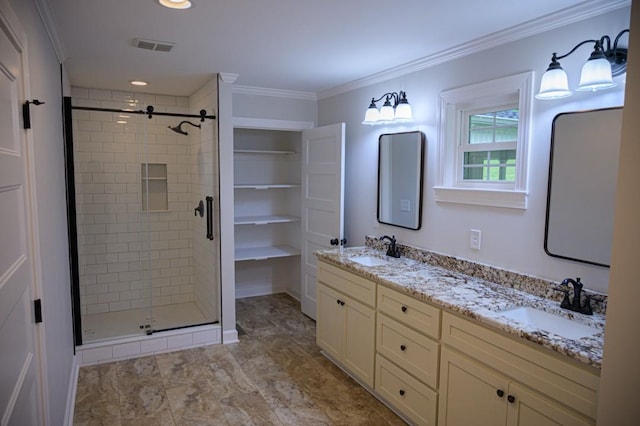 full bath with a stall shower, ornamental molding, double vanity, and a sink
